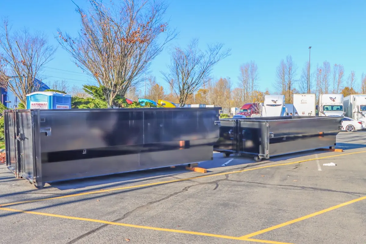 Professional dumpster rental service with roll-off container on residential driveway in Virginia